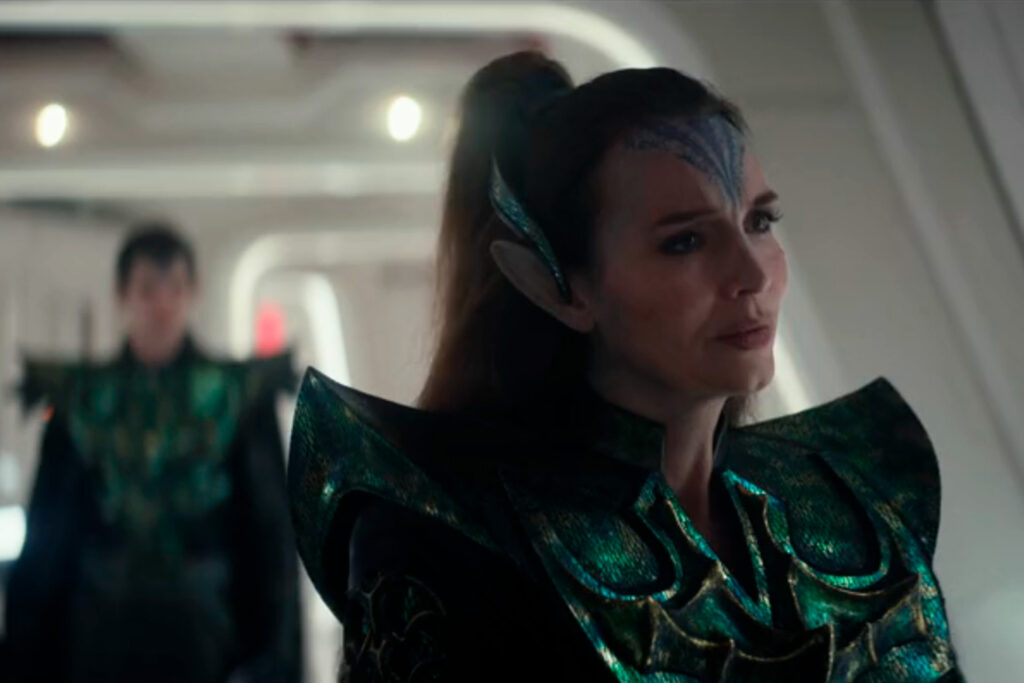 Battle Commander Cassell who is a Martian from mars with pointy ears and dressed all in green stands in the corridor of the Enterprise from Star Trek: Strange New Worlds season four episode one Valles Marineris.